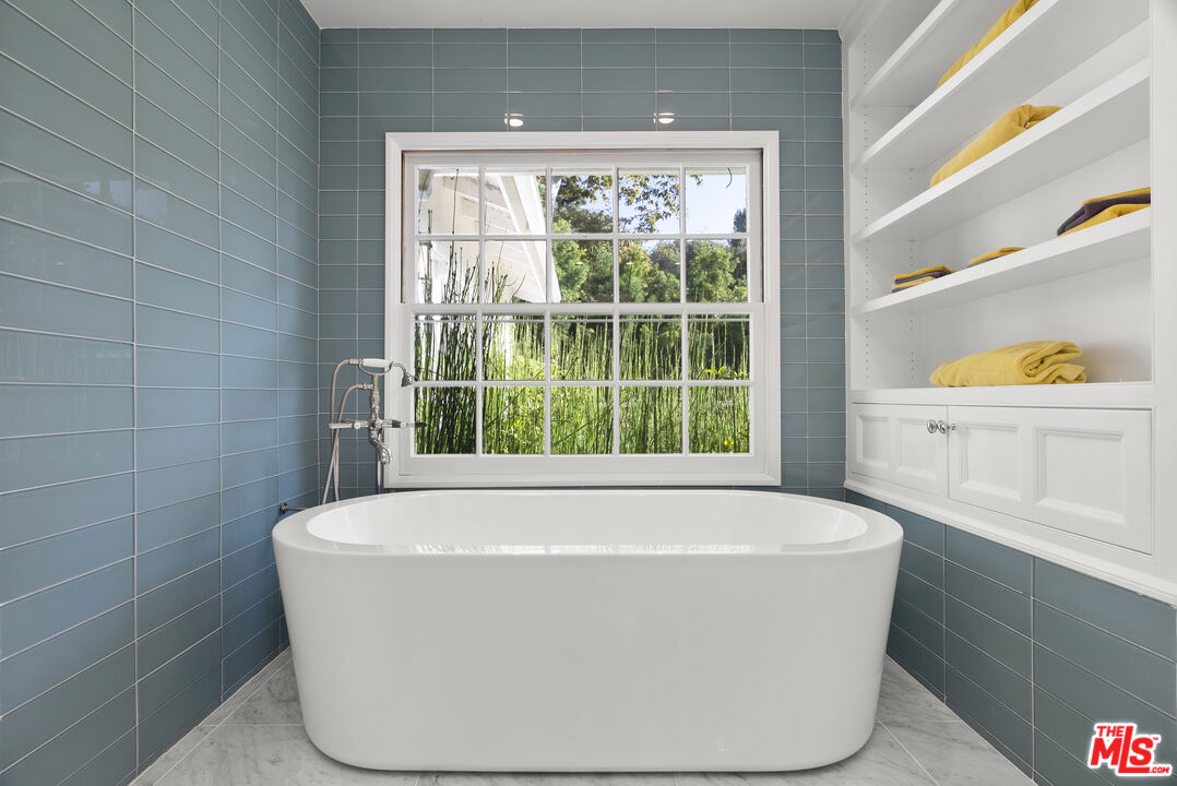 2761 Hutton Drive Beverly Hills, CA 90210 - Photo 18 of 29 a white bath tub sitting in a bathroom