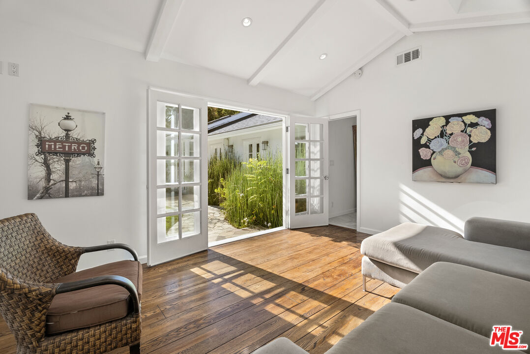 2761 Hutton Drive Beverly Hills, CA 90210 - Photo 20 of 29 a bedroom with a bed couch and a large window