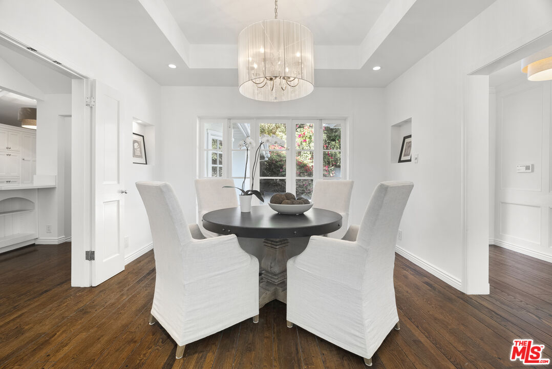 2761 Hutton Drive Beverly Hills, CA 90210 - Photo 8 of 29 a view of a dining room with furniture a chandelier and wooden floor
