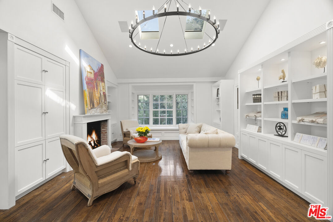 2761 Hutton Drive Beverly Hills, CA 90210 - Photo 10 of 29 a living room with furniture and a chandelier