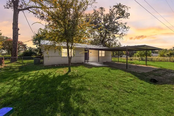 a view of house with backyard