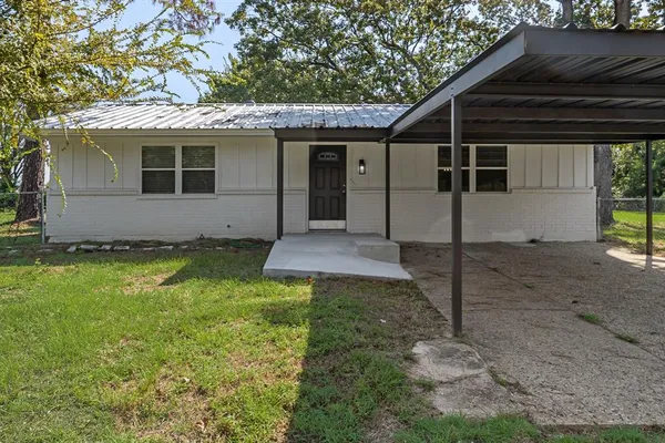 a view of a house with backyard and chairs