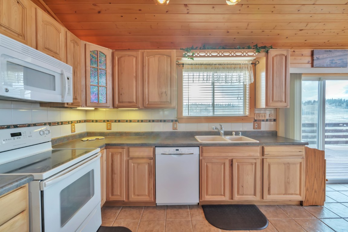 64 Flint Circle Como, CO 80456 - Photo 11 of 35 a kitchen with a sink stove and cabinets