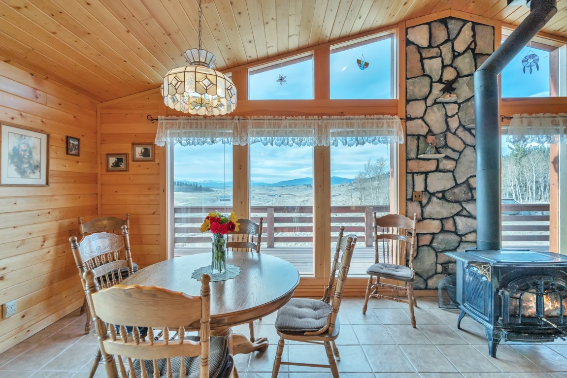 64 Flint Circle Como, CO 80456 - Photo 13 of 35 a dining room with furniture a floor to ceiling window and a table