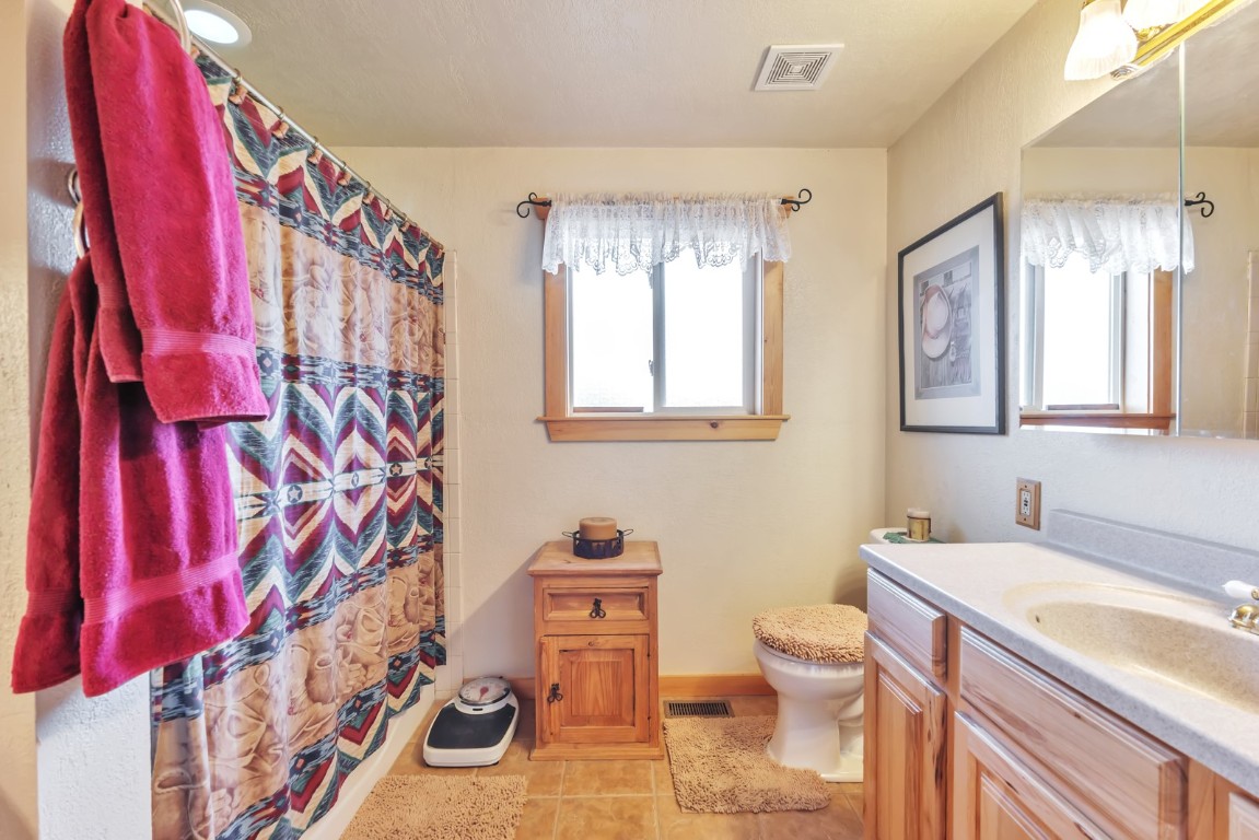 64 Flint Circle Como, CO 80456 - Photo 20 of 35 a bathroom with a granite countertop sink mirror vanity and toilet