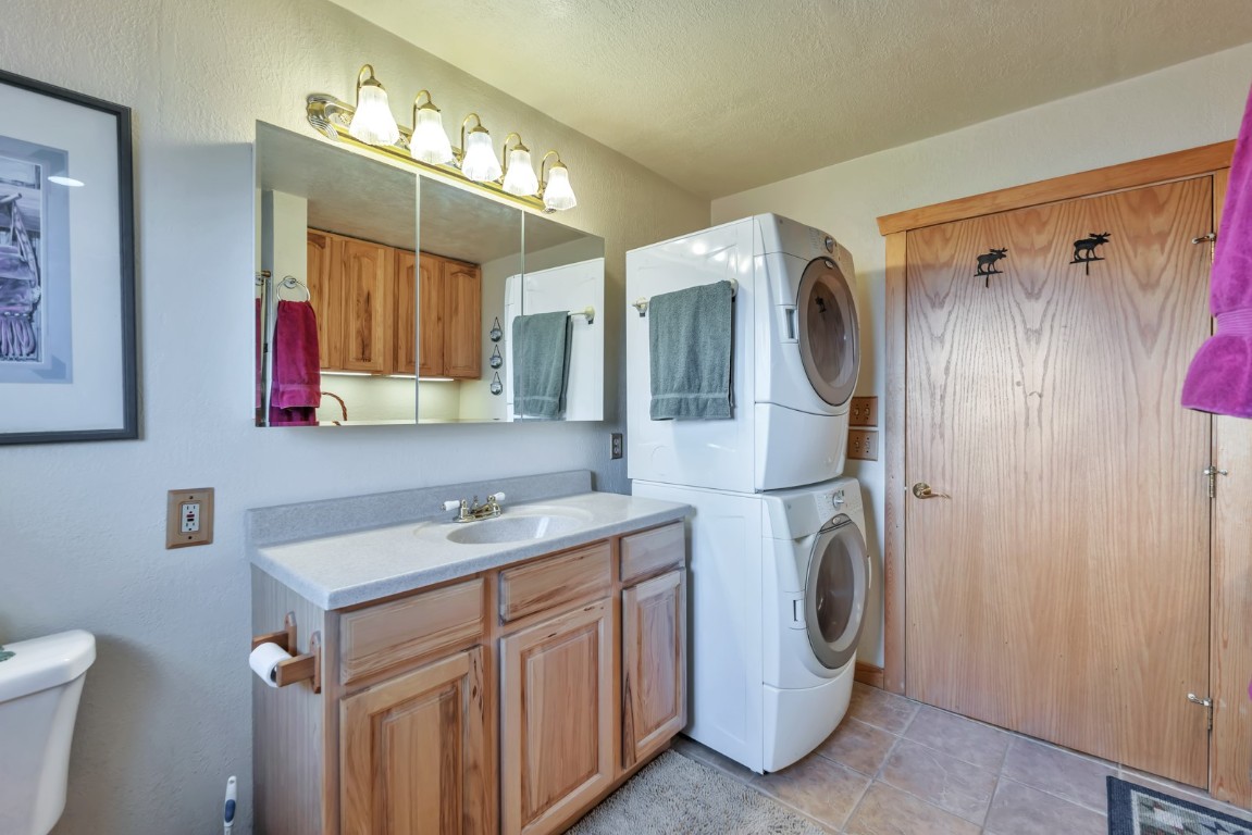 64 Flint Circle Como, CO 80456 - Photo 21 of 35 a bathroom with a sink a washer and dryer