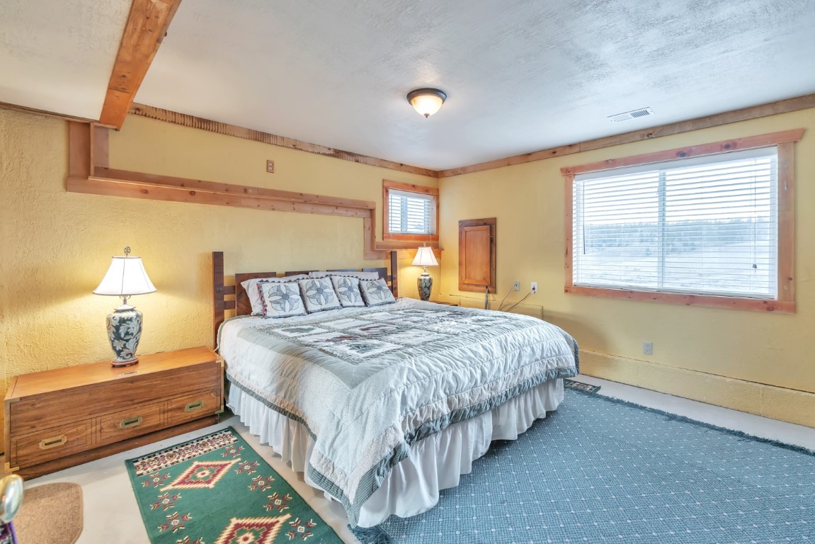 64 Flint Circle Como, CO 80456 - Photo 22 of 35 a bedroom with a bed lamp and a large window