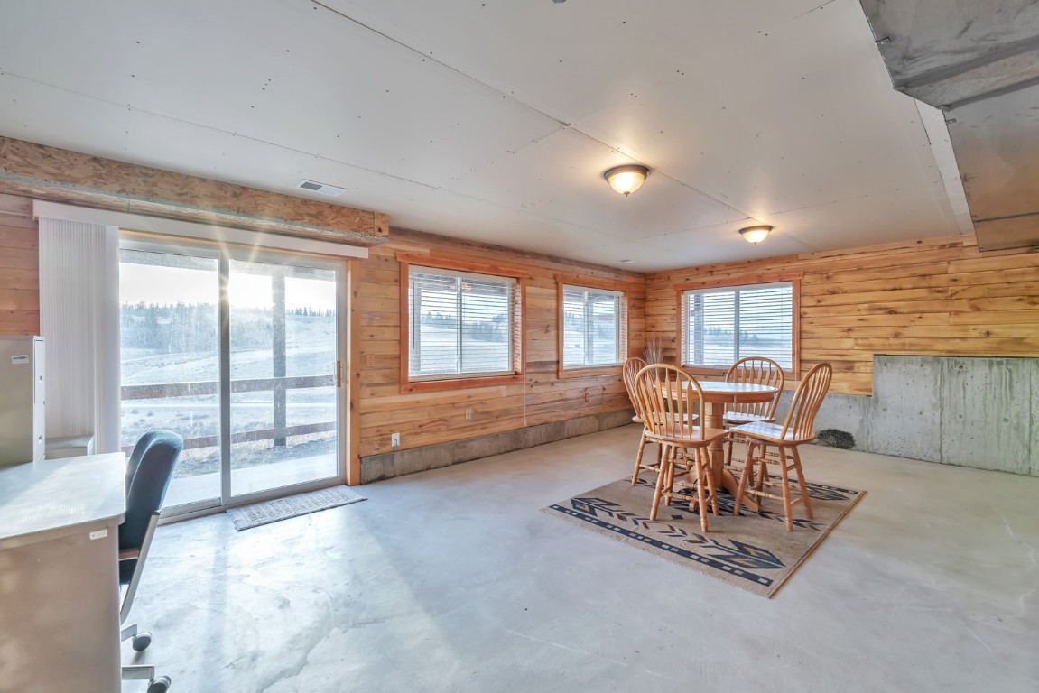 64 Flint Circle Como, CO 80456 - Photo 25 of 35 a dining room with furniture and a floor to ceiling window