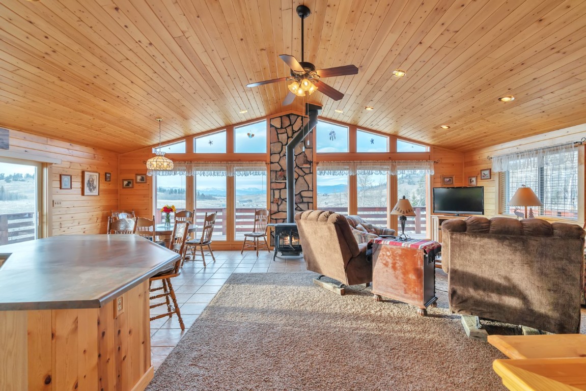 64 Flint Circle Como, CO 80456 - Photo 10 of 35 a dining room with furniture a chandelier and a floor to ceiling window