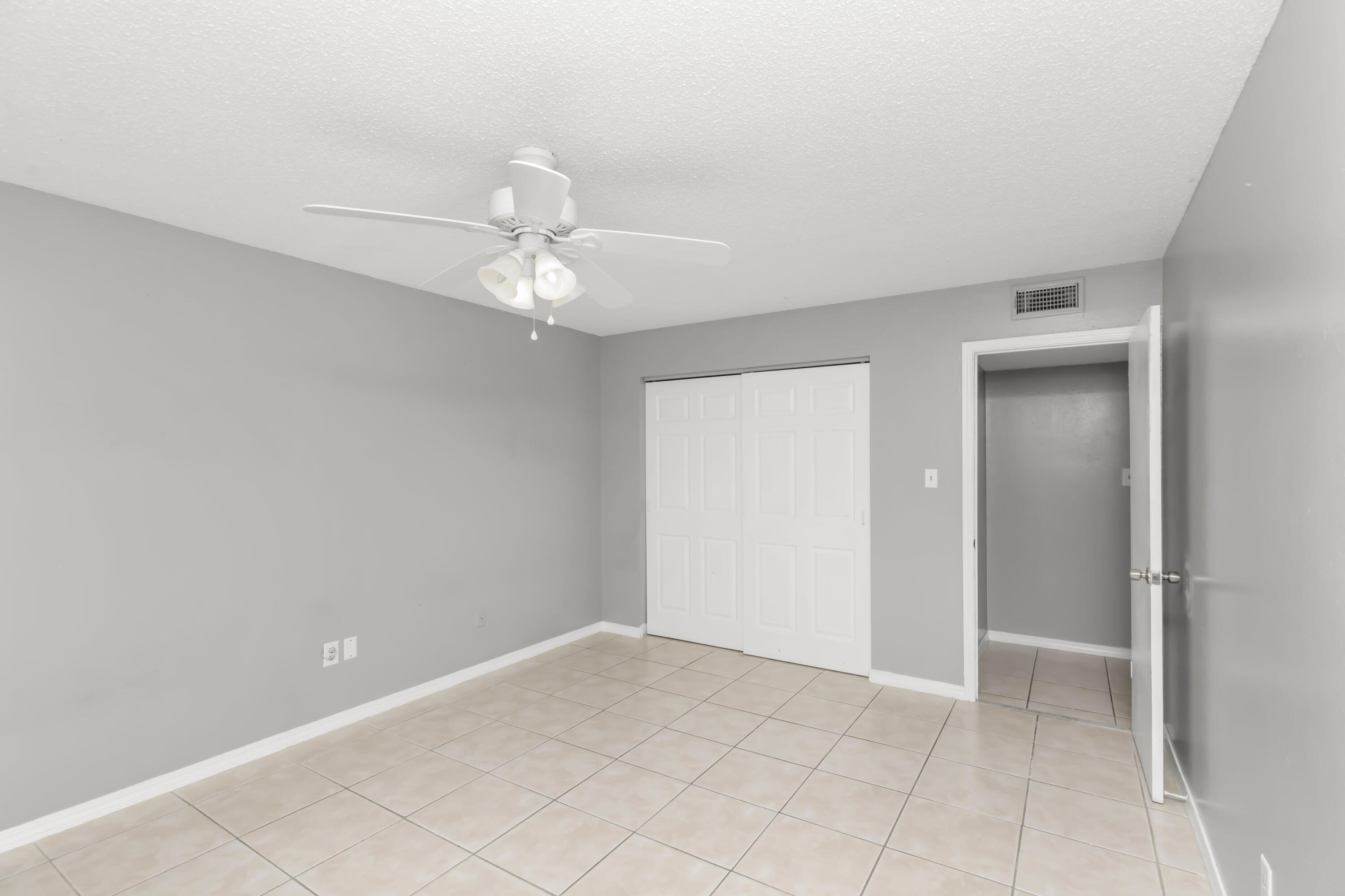 210 Pelham Road, Unit 219A Fort Walton Beach, FL 32547 - Photo 26 of 34 a view of an empty room with a ceiling fan
