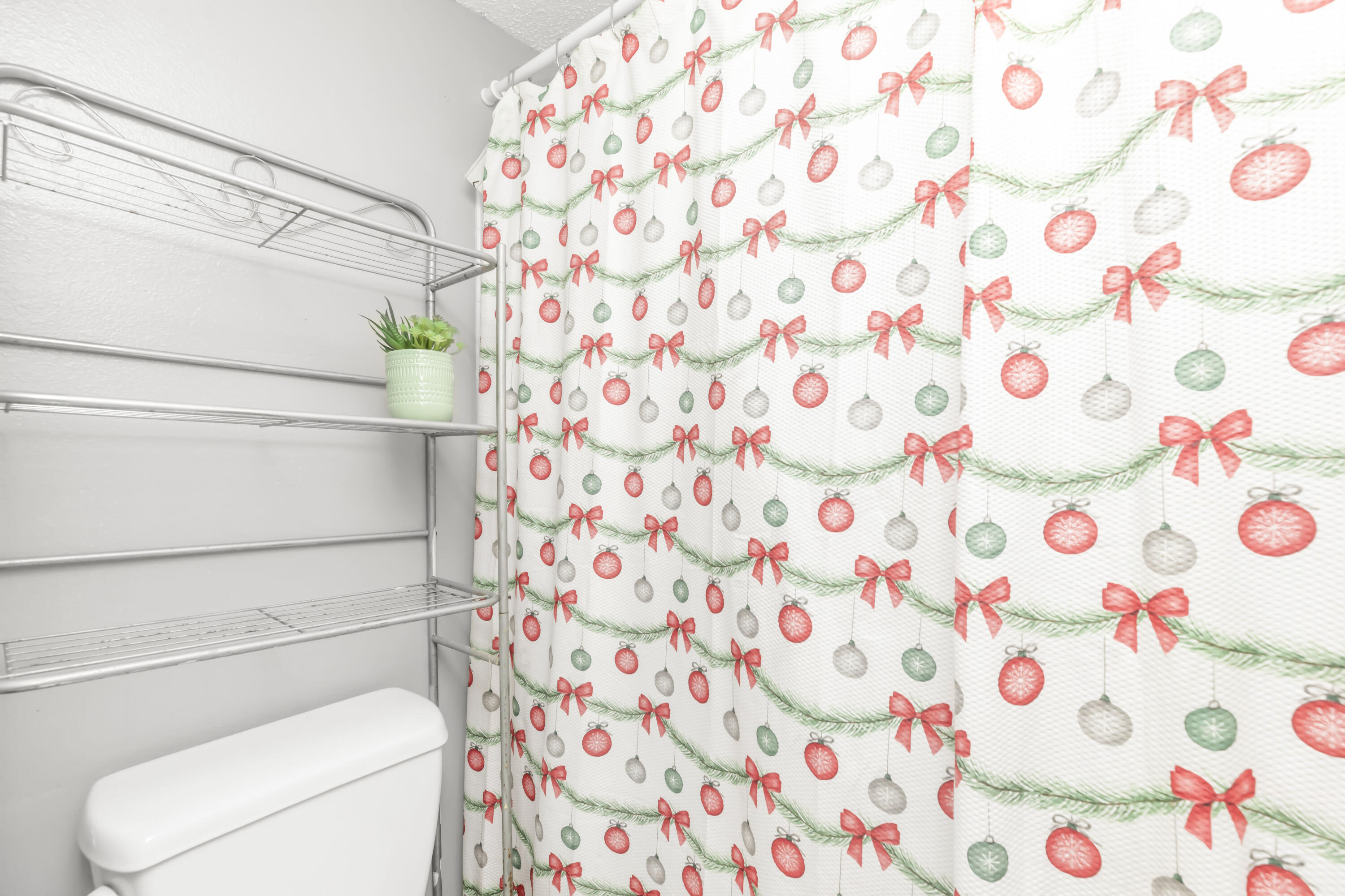 210 Pelham Road, Unit 219A Fort Walton Beach, FL 32547 - Photo 29 of 34 a bathroom with a toilet and a shower curtain