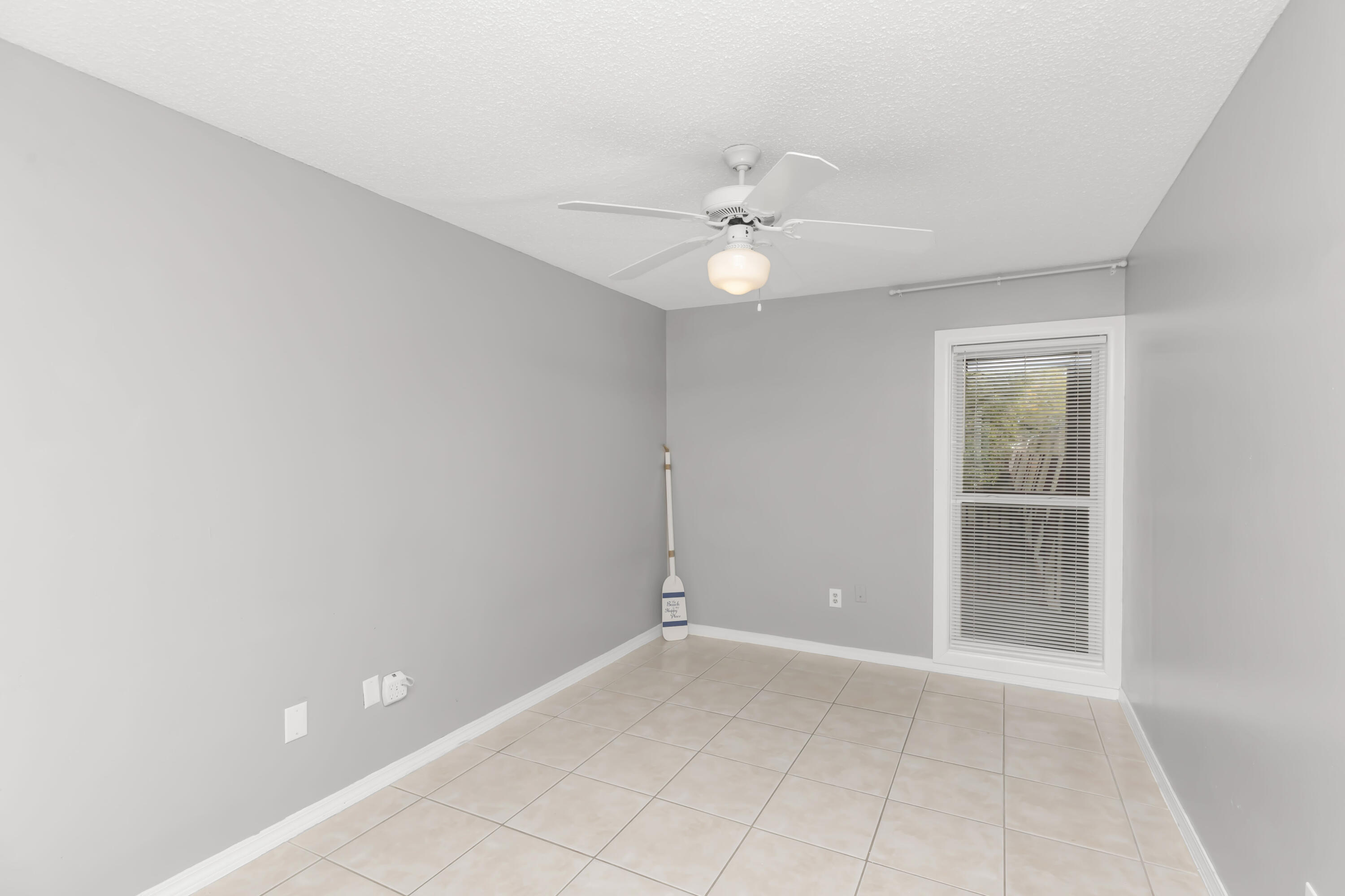 210 Pelham Road, Unit 219A Fort Walton Beach, FL 32547 - Photo 32 of 34 an empty room with a window and a fan