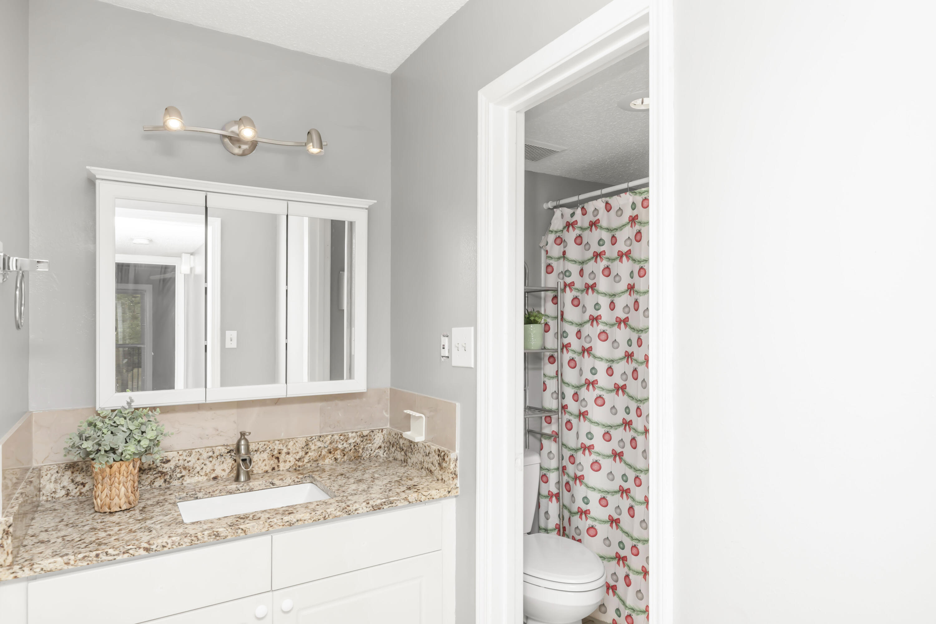 210 Pelham Road, Unit 219A Fort Walton Beach, FL 32547 - Photo 6 of 34 a bathroom with a granite countertop sink a mirror and shower