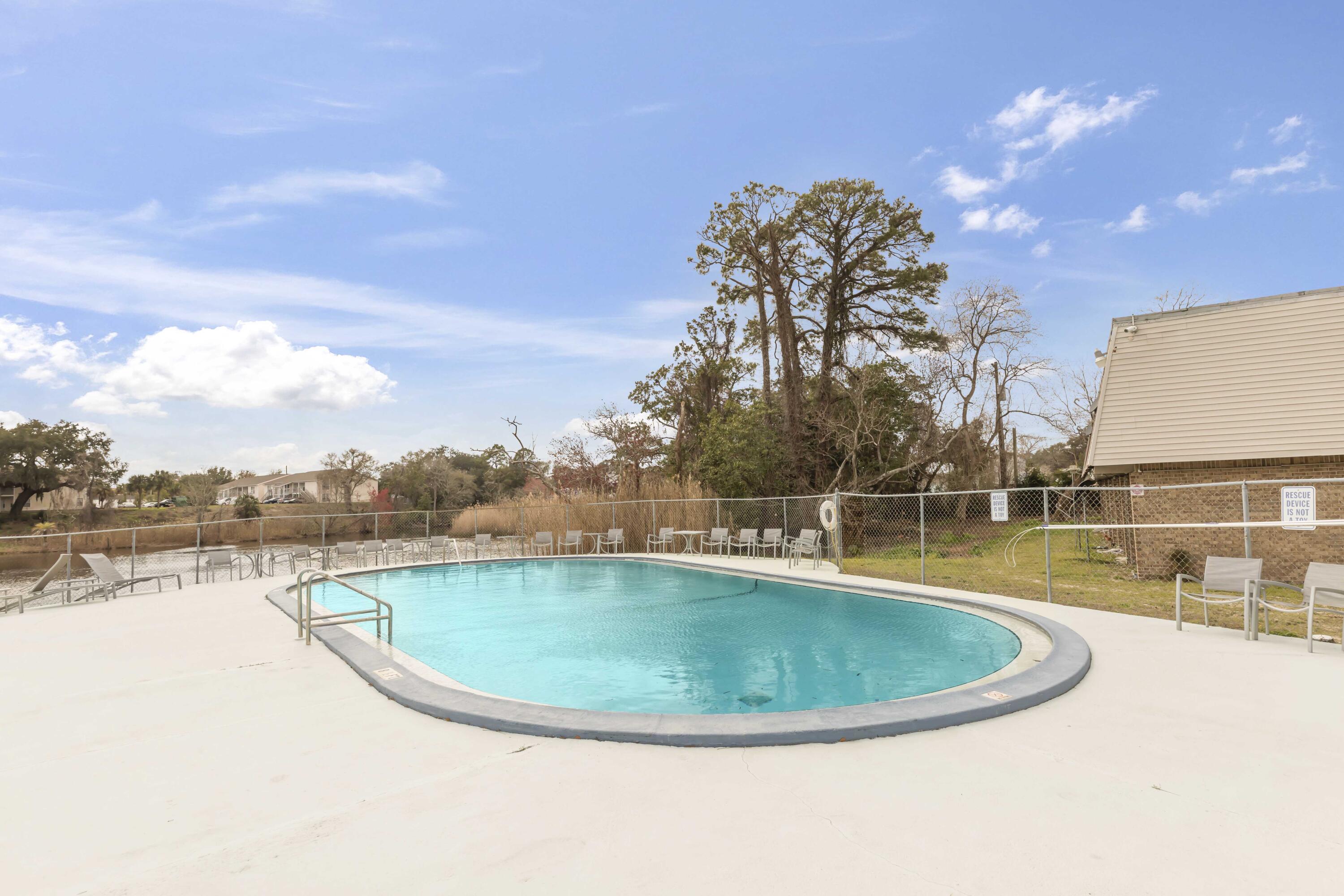 210 Pelham Road, Unit 219A Fort Walton Beach, FL 32547 - Photo 8 of 34 a view of a swimming pool with lake view