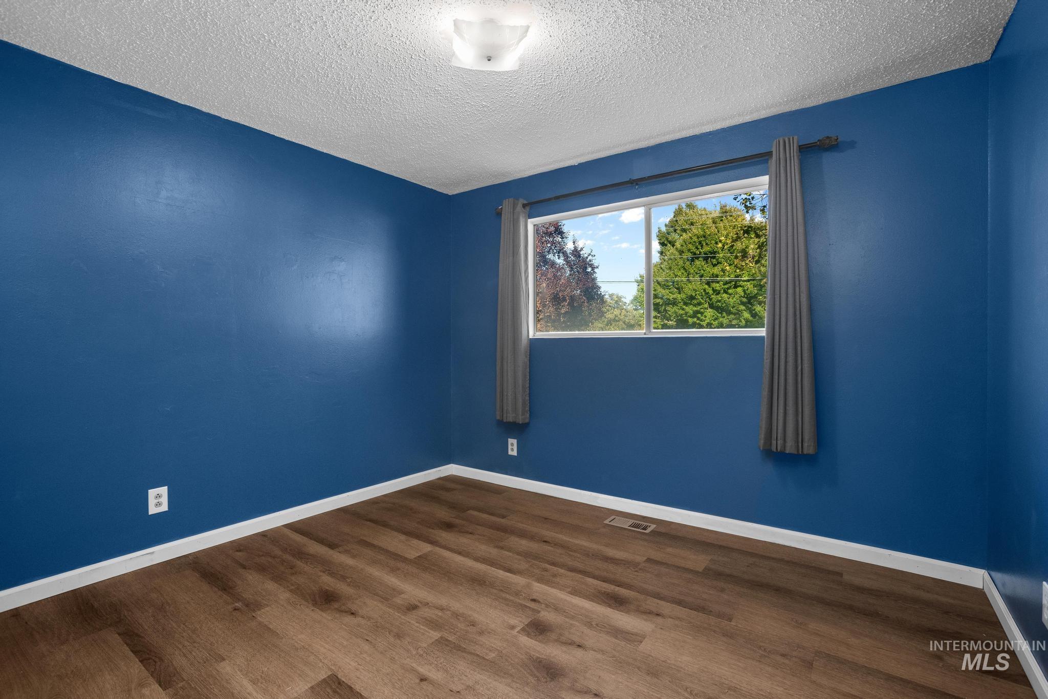 2037 South Curtis Road Boise, ID 83705 - Photo 20 of 32 Wood-finish flooring, white trim, recessed lighting, and a clear window