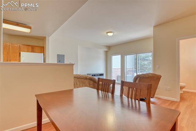 2049 Legacy Ridge View, Unit 111 Colorado Springs, CO 80910 - Photo 14 of 32 Dining room with light wood-style floors and electric panel