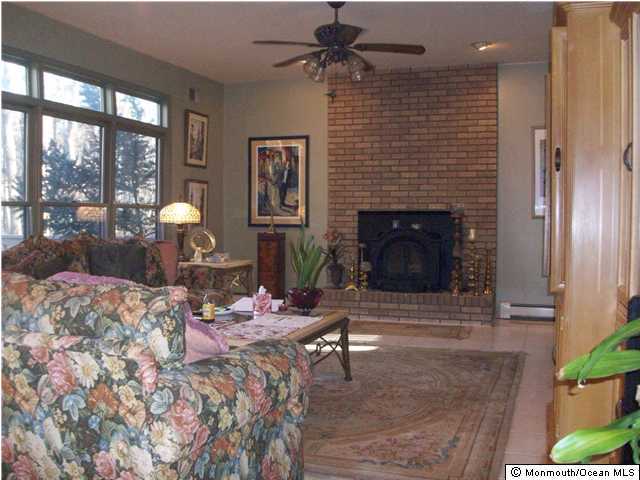 327 Friendship Road Howell, NJ 07731 - Photo 3 of 3 a living room with furniture and a fireplace