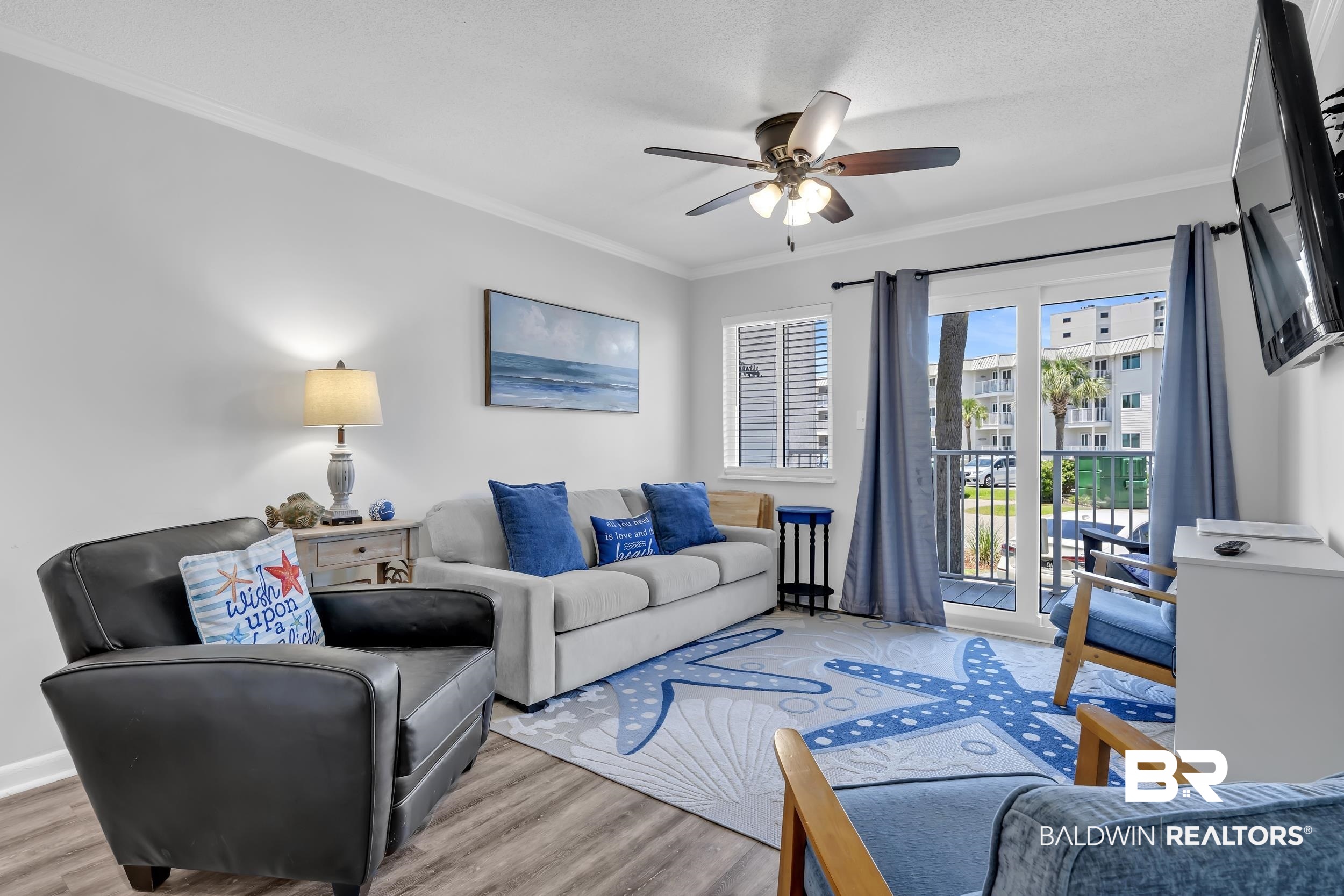 400 Plantation Road, Unit 2118 Gulf Shores, AL 36542 - Photo 2 of 59 Living space featuring wood-finish flooring, a ceiling fan, crown molding, and a sliding glass door to an outdoor balcony
