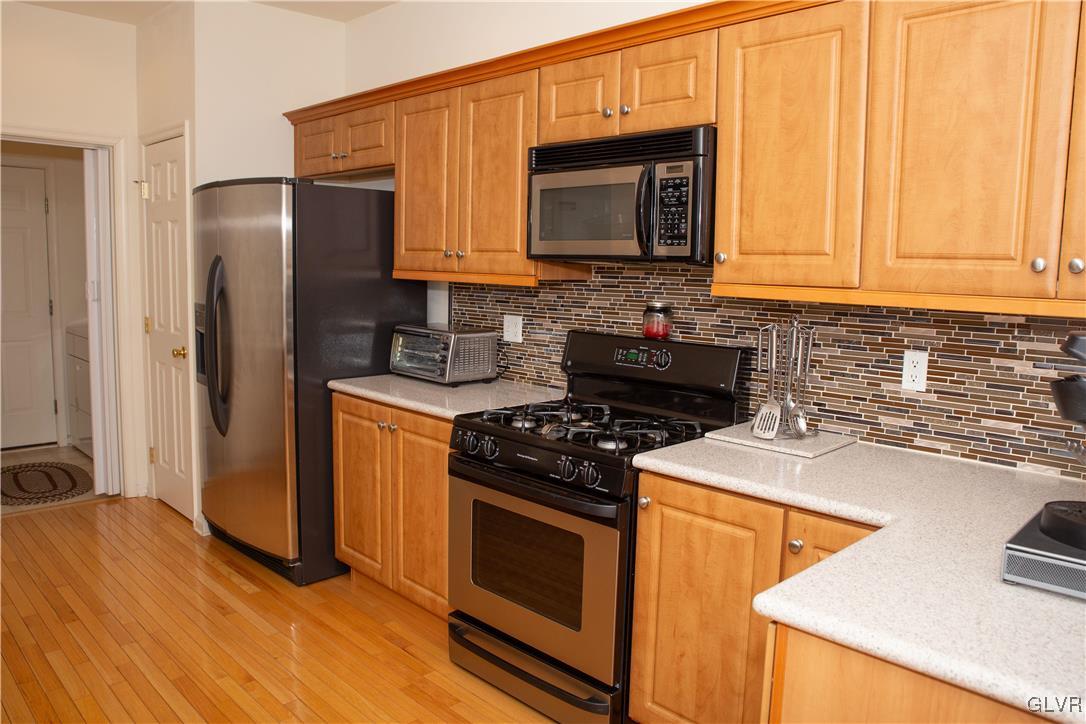 147 Pinehurst Lane Easton, PA 18042 - Photo 11 of 31 a kitchen with stainless steel appliances granite countertop a stove microwave refrigerator sink and cabinets