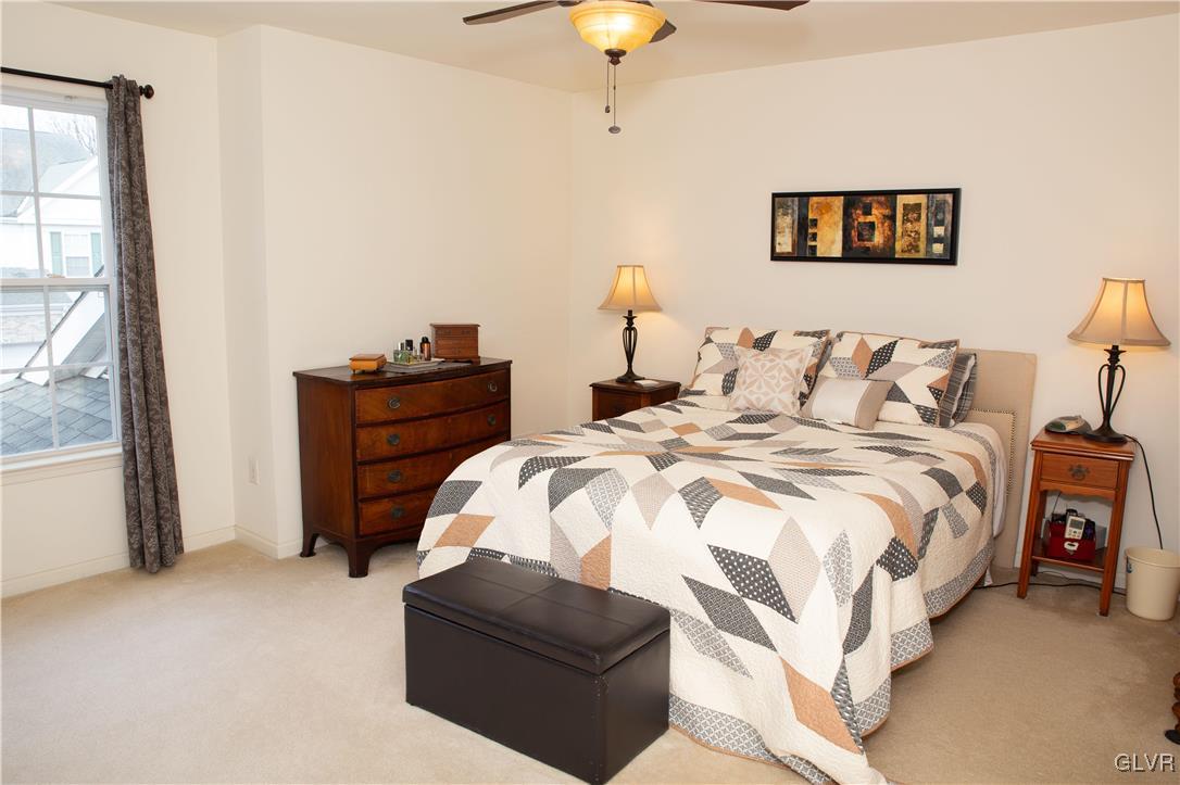 147 Pinehurst Lane Easton, PA 18042 - Photo 14 of 31 a bedroom with a bed and a chandelier