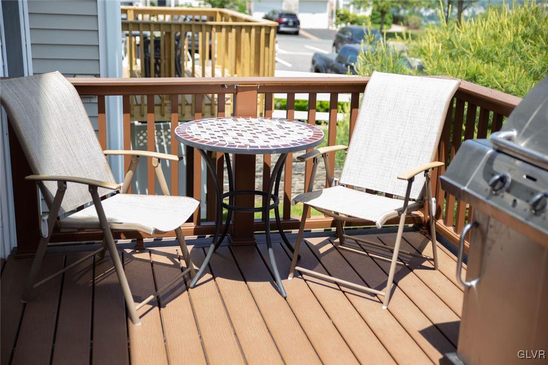 147 Pinehurst Lane Easton, PA 18042 - Photo 21 of 31 a roof deck with a dining table and chairs with wooden floor