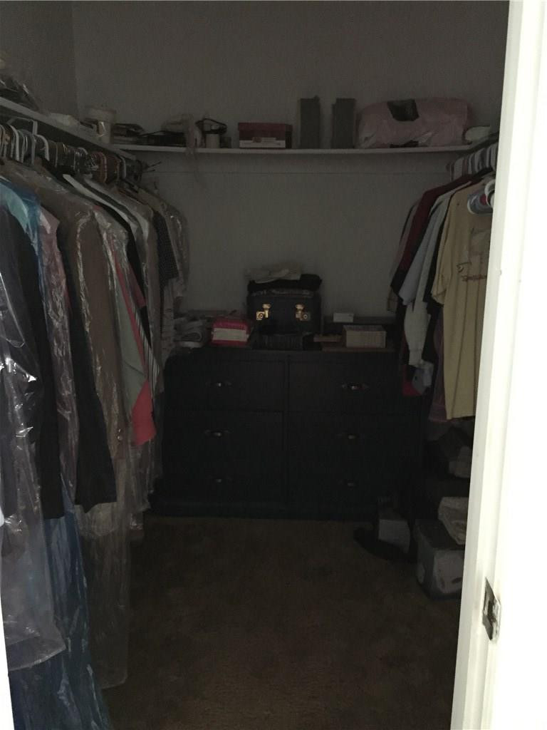 9369 Southwest 16th Street Boca Raton, FL 33428 - Photo 10 of 17 a view of walk in closet with clothes and shoes