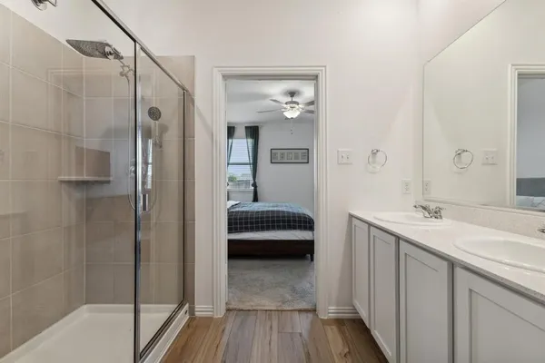 a bathroom with a sink a toilet and shower