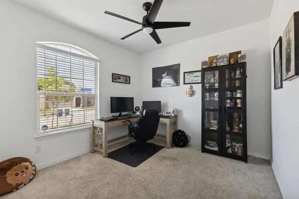 a view of a livingroom with workspace and a window