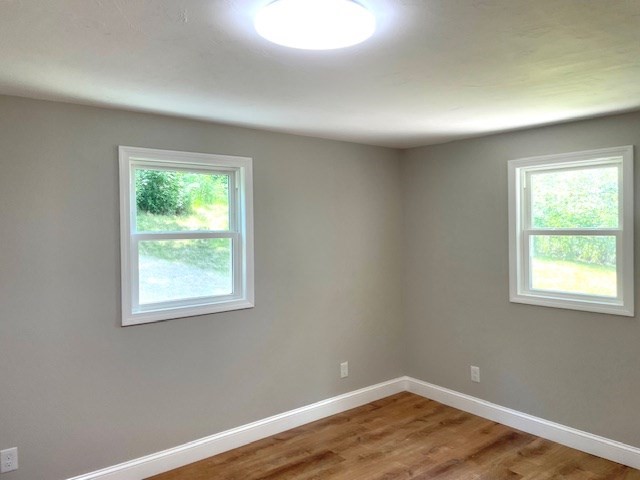 73 Cairn Road Brockton, MA 02302 - Photo 5 of 10 an empty room with wooden floor and a window
