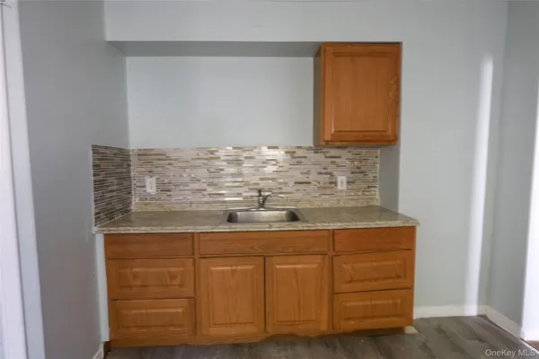 a kitchen with granite countertop cabinets stainless steel appliances and a counter space
