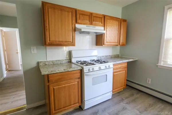 an open kitchen with granite countertop a sink and a stove