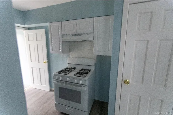 a kitchen with a refrigerator and a stove