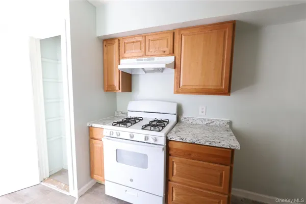 a kitchen with a stove and cabinets