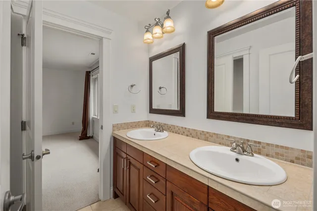 a bathroom with 2 sink and a mirror