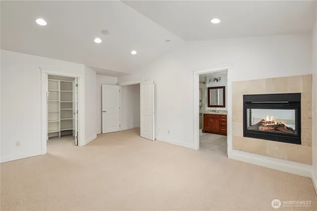 an empty room with furniture and a fireplace