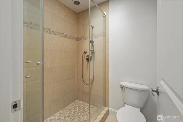 a bathroom with a toilet and shower