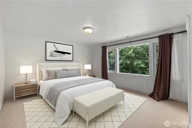 a bedroom with a large bed and a large window