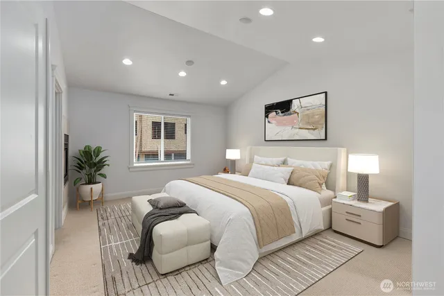 a spacious bedroom with a large bed and a potted plant