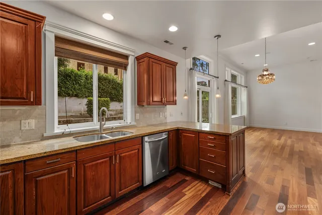 a large kitchen with wooden cabinets and a sink