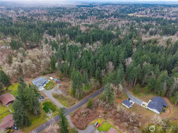 an aerial view of a house with a yard