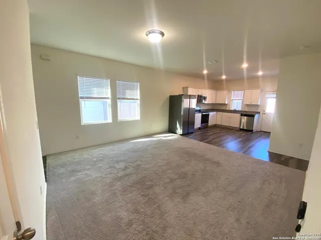 a view of a livingroom with furniture and a window