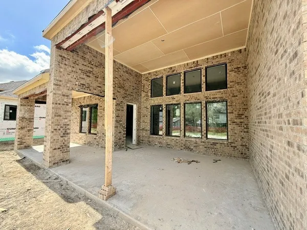 a view of a house with a wooden fence