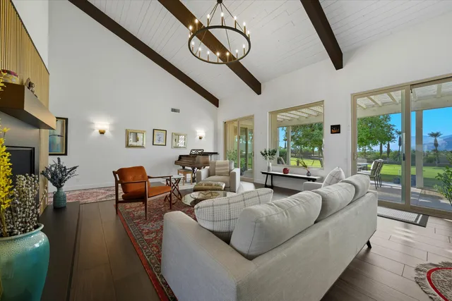 a living room with furniture ceiling fan and a flat screen tv
