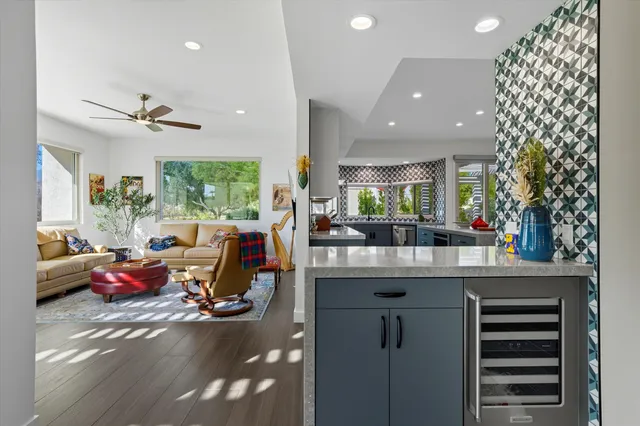 a very nice looking room with kitchen island furniture and a chandelier