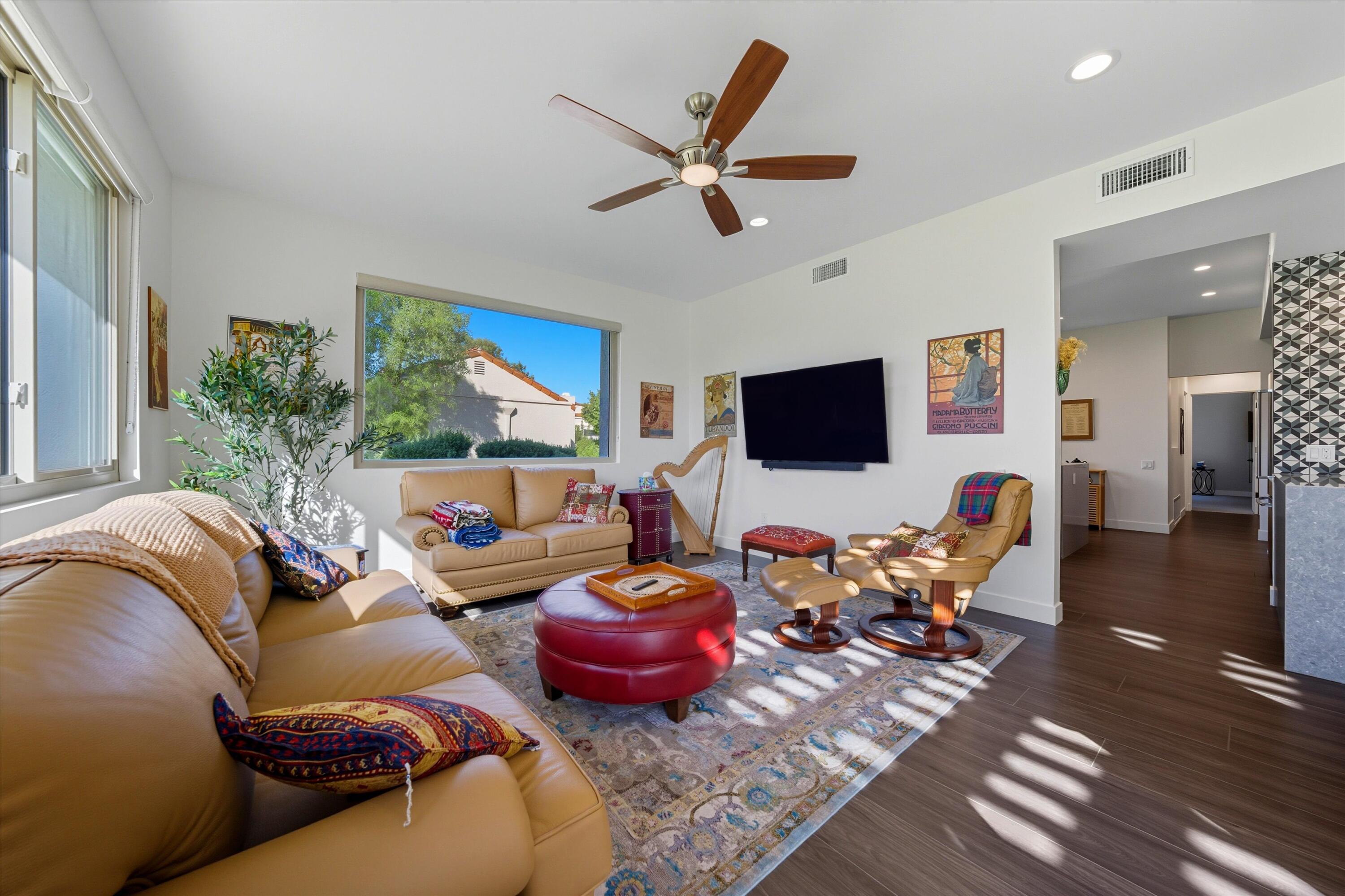 809 Inverness Drive Rancho Mirage, CA 92270 - Photo 20 of 36 a living room with furniture a flat screen tv and a large window