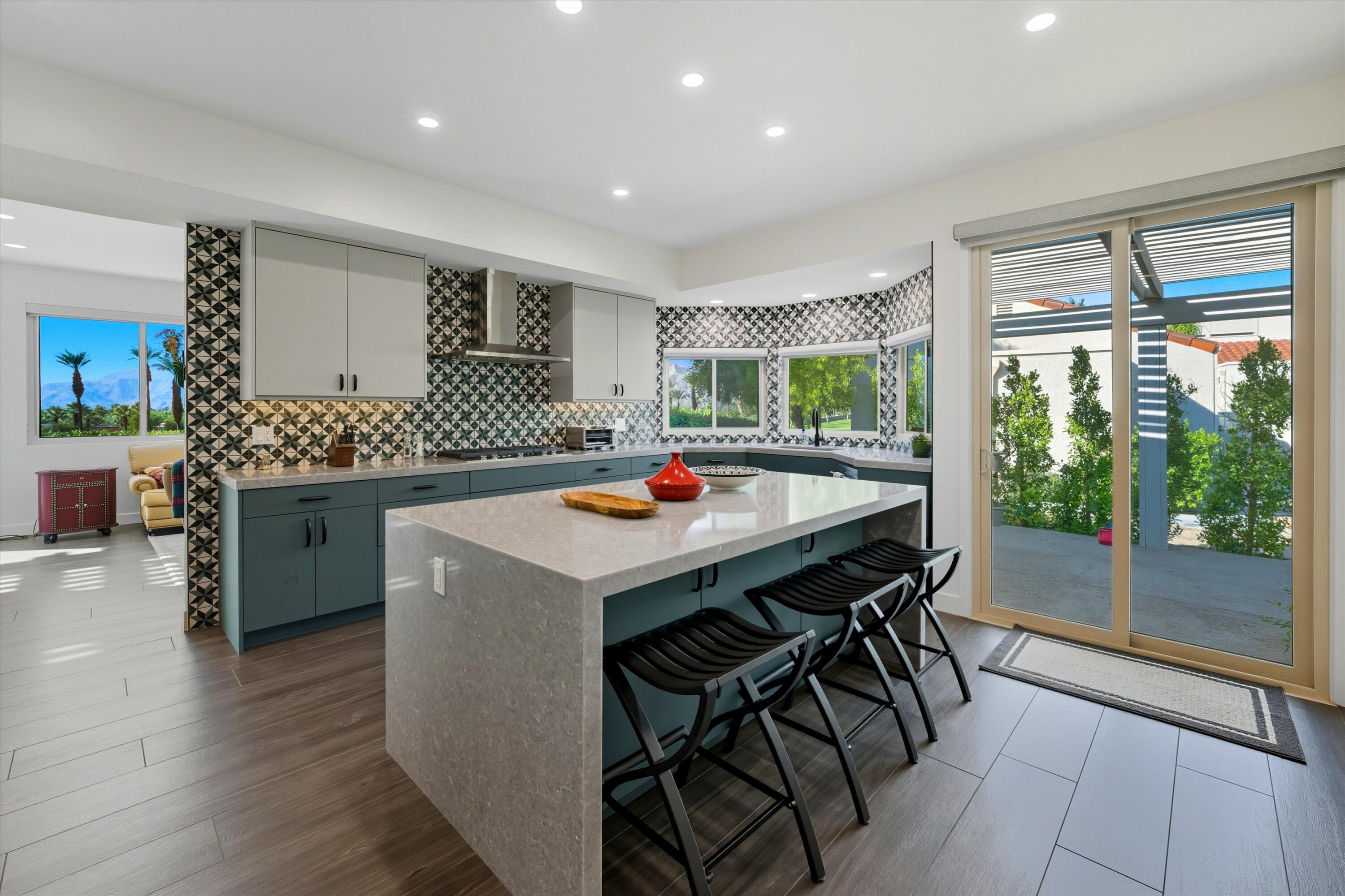 809 Inverness Drive Rancho Mirage, CA 92270 - Photo 23 of 36 a table and chairs in a room with kitchen view