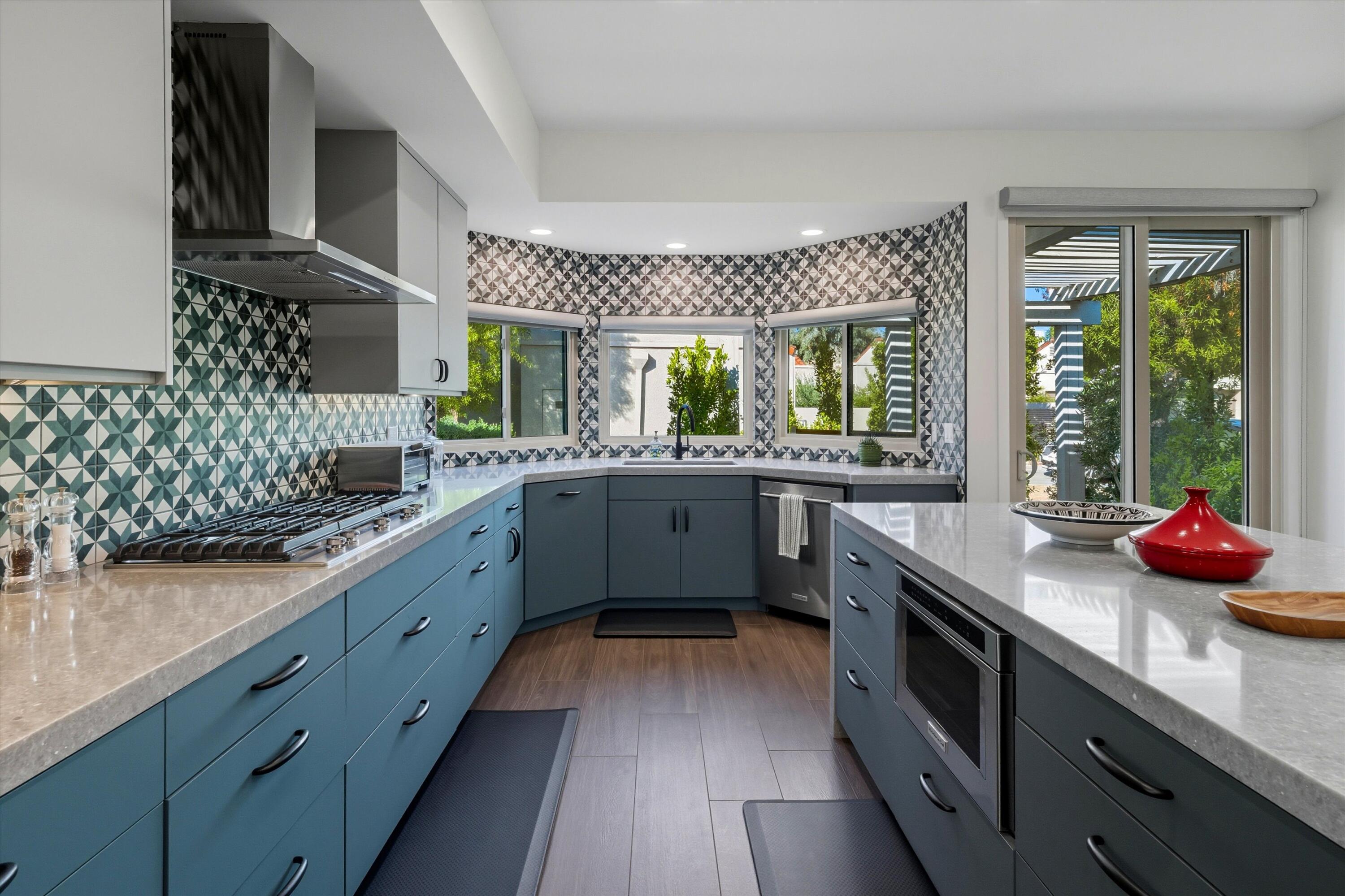 809 Inverness Drive Rancho Mirage, CA 92270 - Photo 25 of 36 a kitchen with stainless steel appliances a sink dishwasher and wooden cabinets