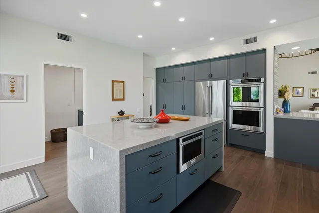 a kitchen with stainless steel appliances a stove a sink and a refrigerator