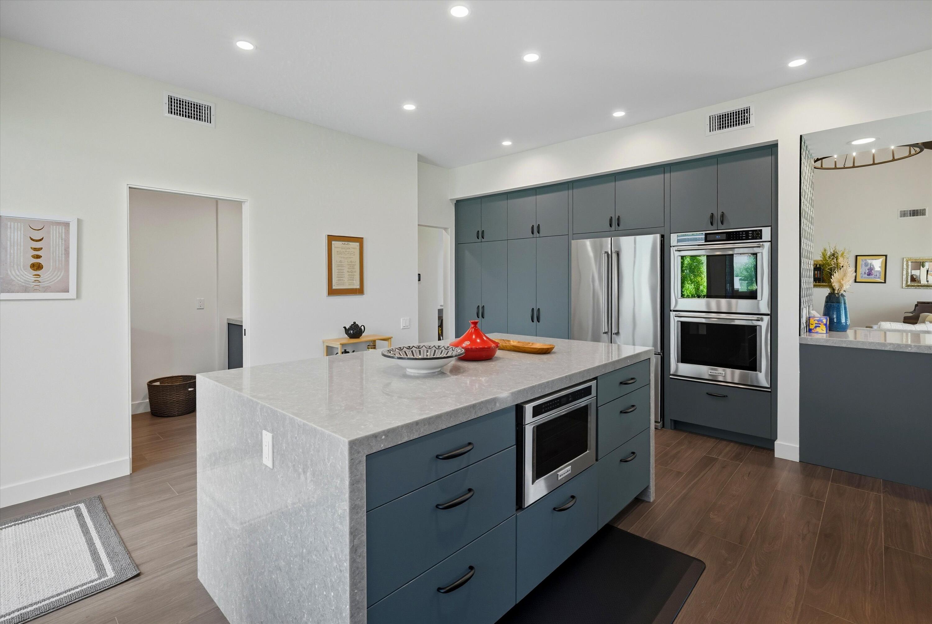 809 Inverness Drive Rancho Mirage, CA 92270 - Photo 26 of 36 a kitchen with stainless steel appliances a stove a sink and a refrigerator