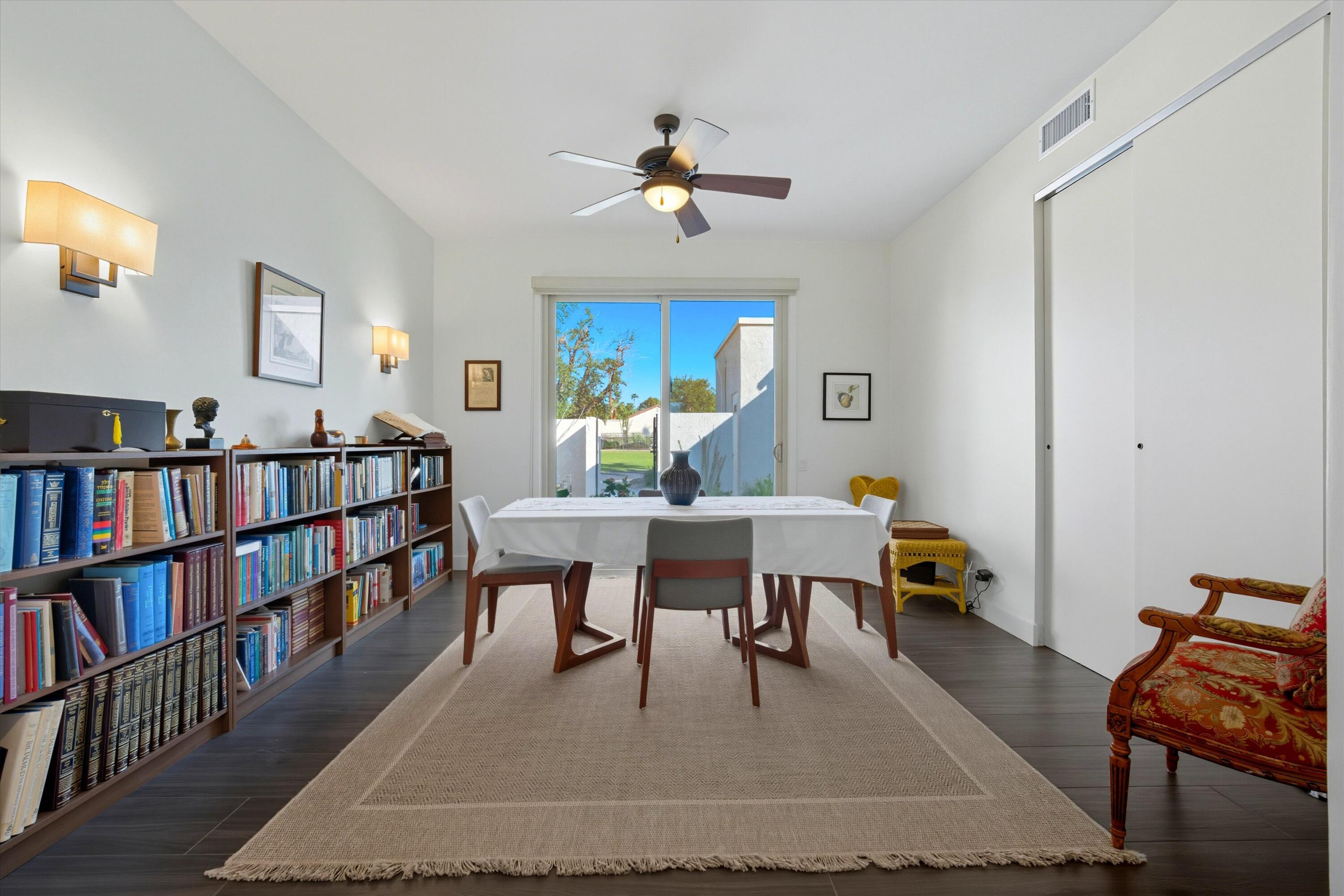 809 Inverness Drive Rancho Mirage, CA 92270 - Photo 28 of 36 a living room with furniture and a book shelf